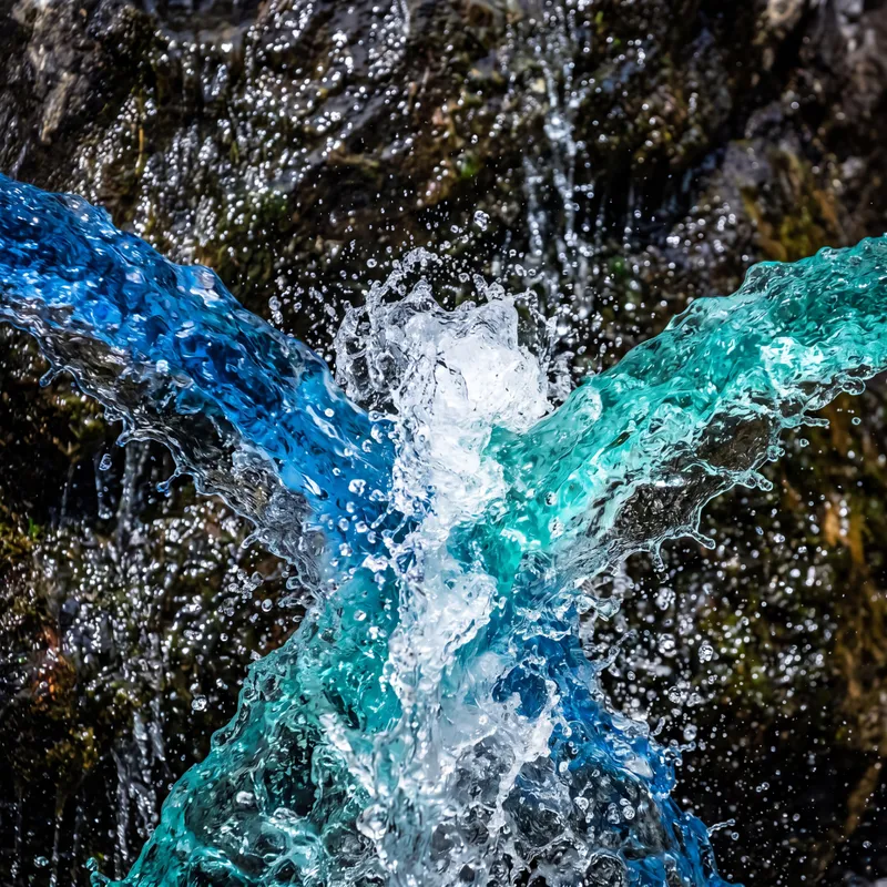 Clashing Colored Water Streams - different color water flowing from each side clashing together - AI image generated with 4K Pro - close-up macro photograph